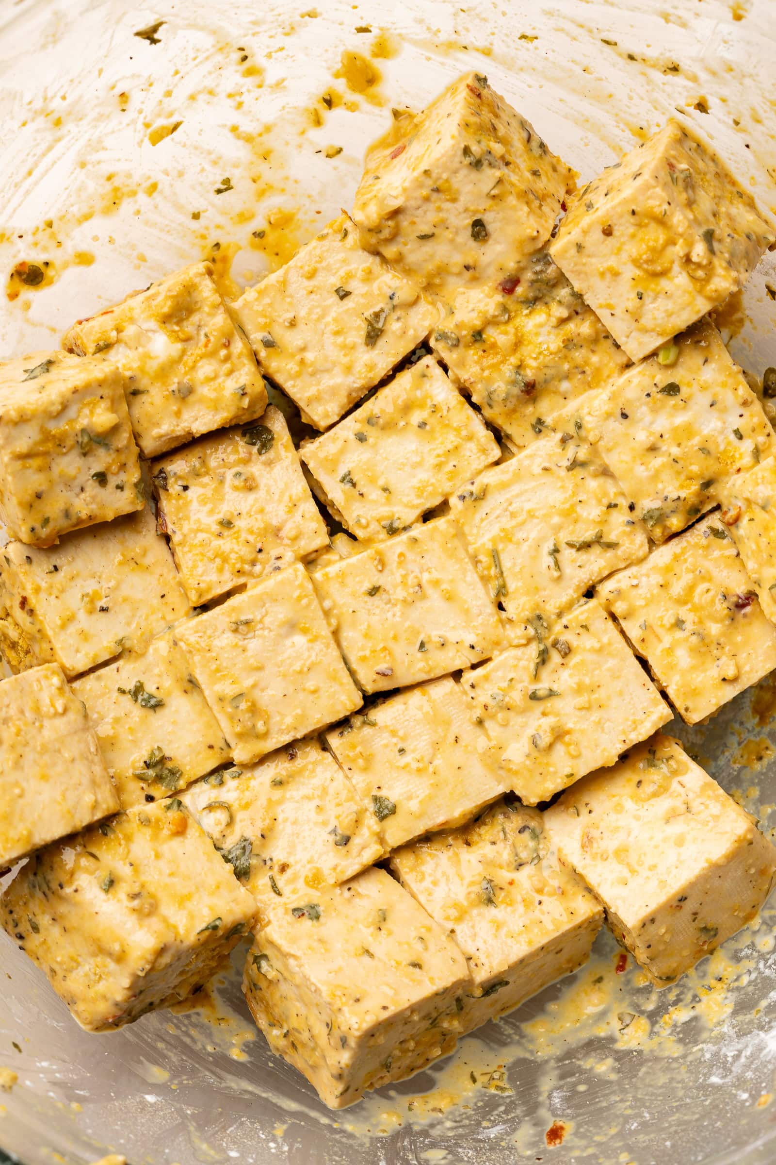 Cornstarch coated tofu in glass bowl.