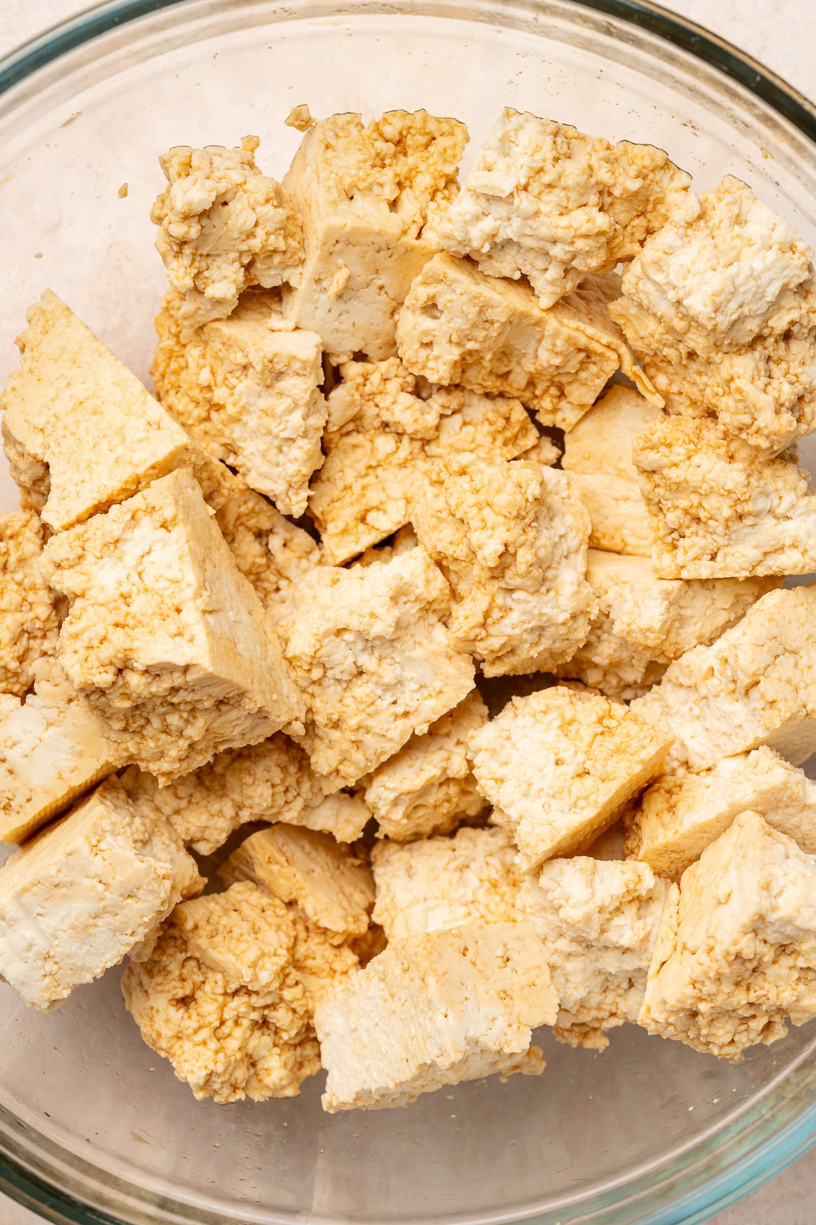 Soy sauce being tossed on the tofu chunks.