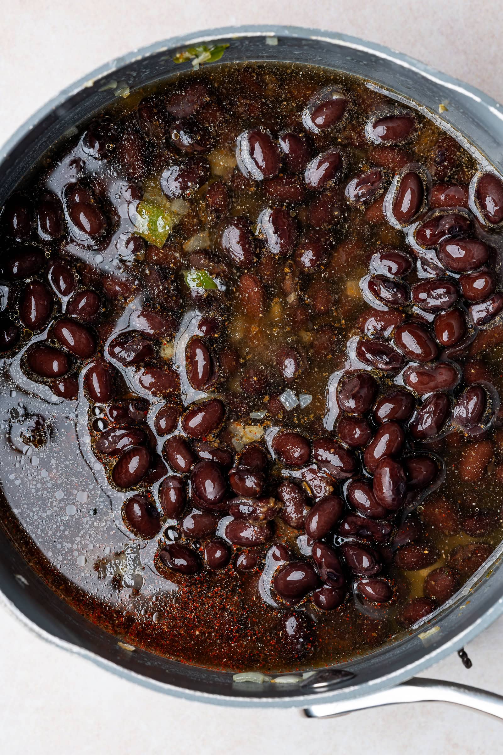 Black bean ingredients combined in a pot.