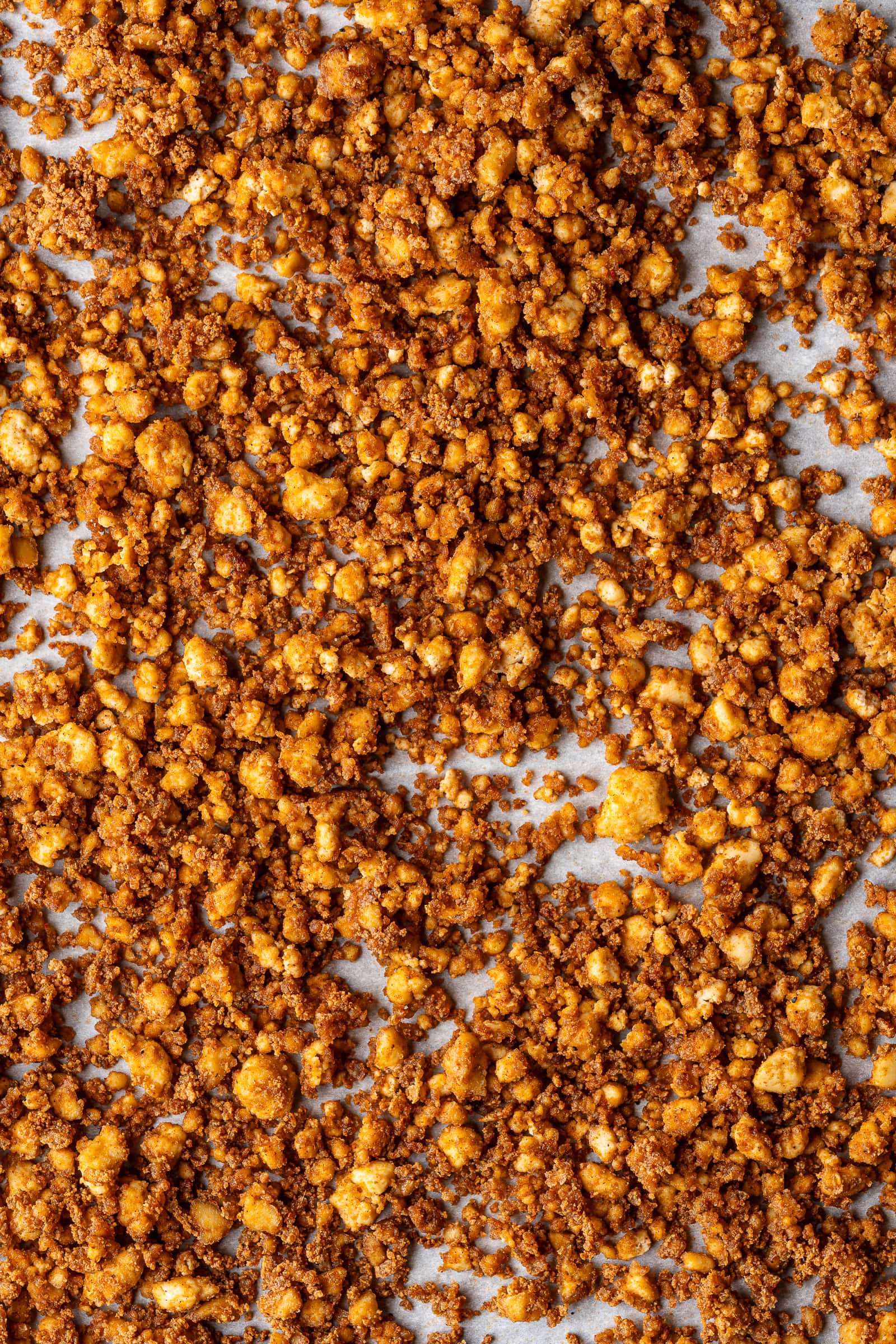 Crispy golden brown tofu crumbles on baking sheet.