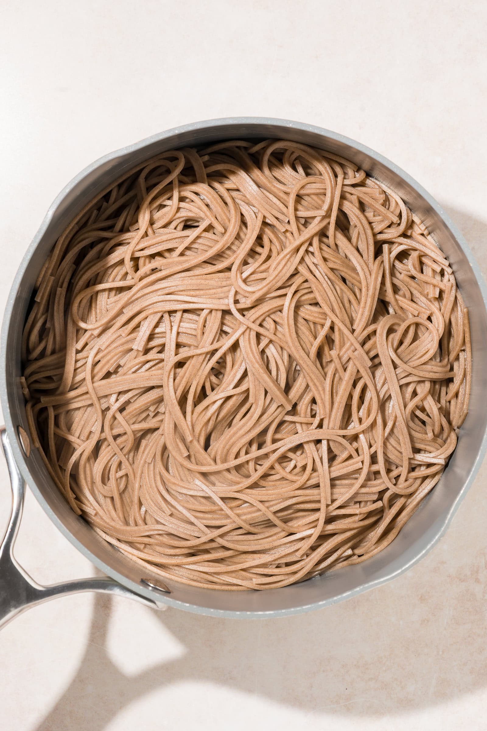 Cooked soba noodles in a pan.