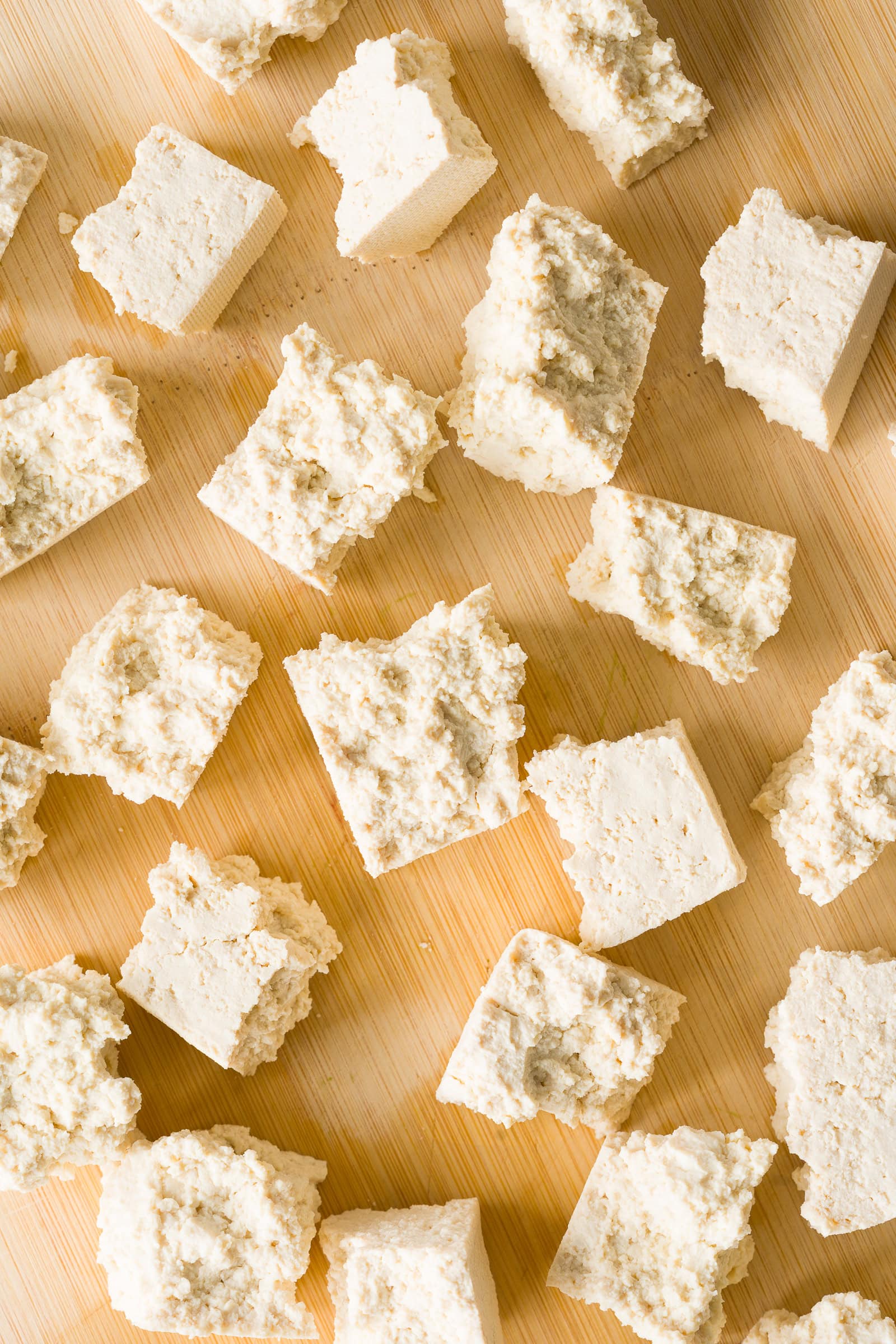 Torn tofu pieces coated in cornstarch before air frying.