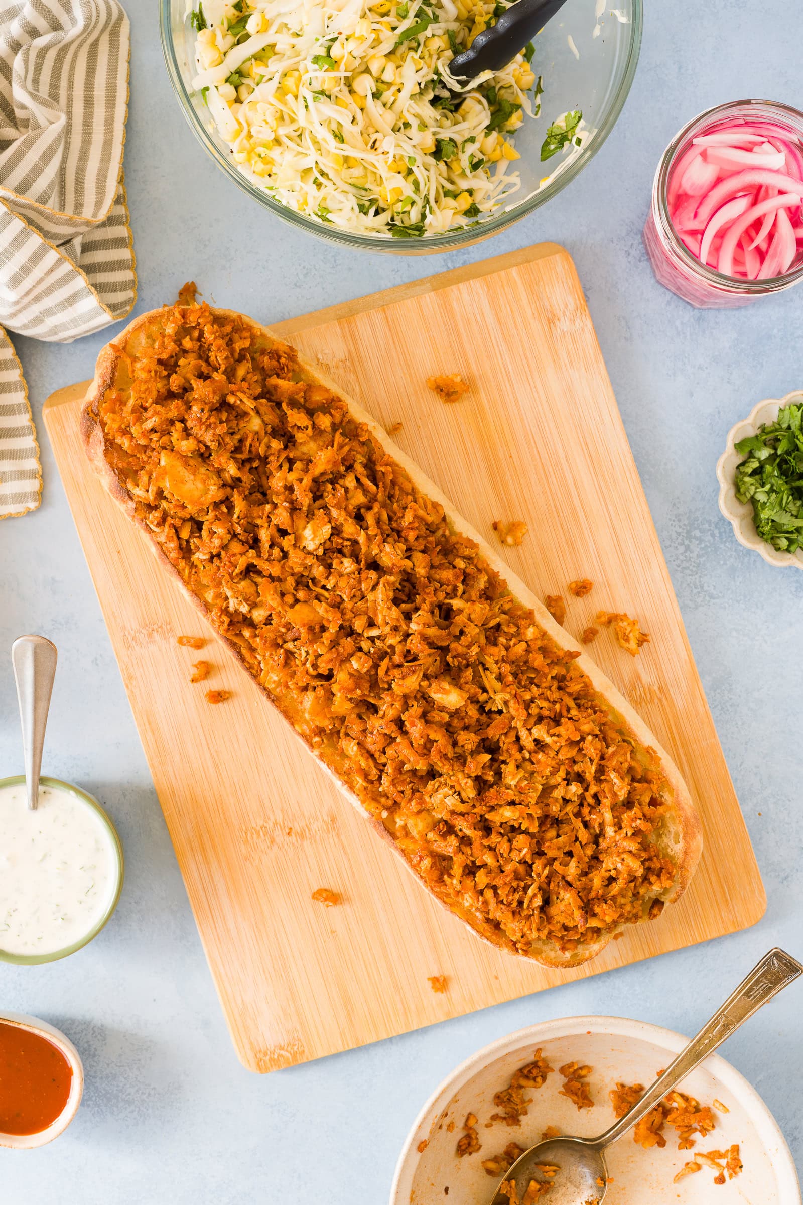 Shredded bbq tofu on a long ciabatta loaf.