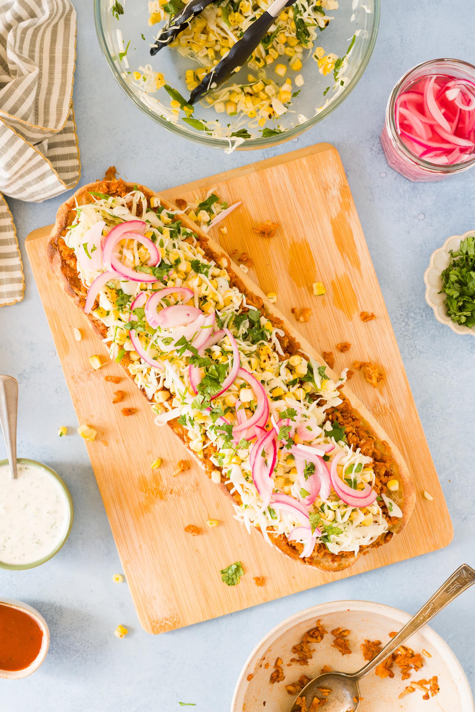 Long ciabatta loaf piled high on bbq tofu and corn cabbage slaw.