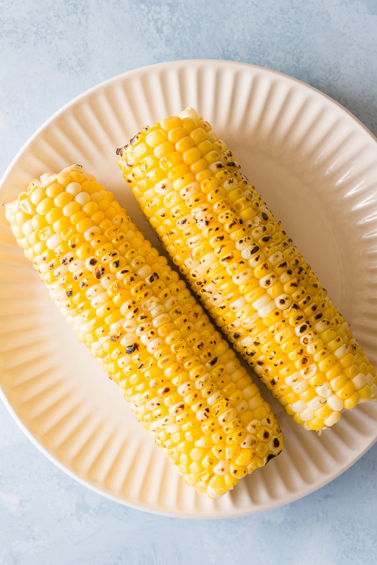 Charred corn on a plate.