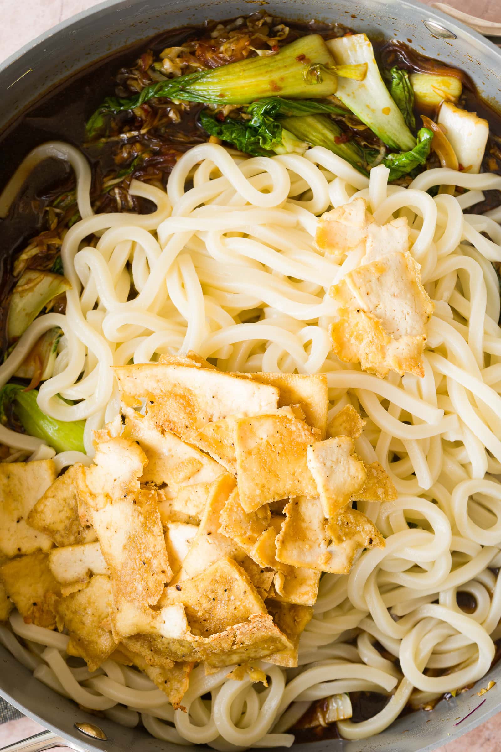 Udon noodles, crispy tofu and chili garlic sauce added to the cooked vegetables.
